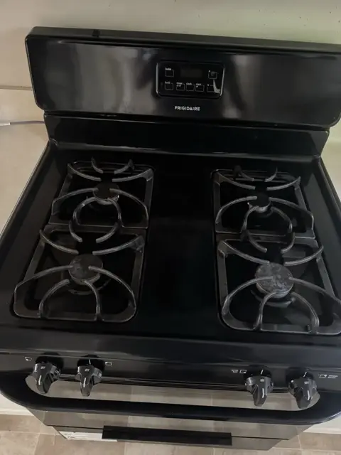 A gas range after cleaning: grates, burners and control panel wiped clean
